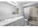 Bathroom featuring a dual sink vanity, shower with glass door, and tiled floors at 1731 Urbana Ave, Deltona, FL 32725