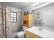 Bright bathroom featuring a tub with shower, toilet, and a vanity sink with storage at 1731 Urbana Ave, Deltona, FL 32725