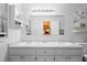 Bright bathroom featuring a dual sink vanity with gold hardware and a large mirror at 1731 Urbana Ave, Deltona, FL 32725