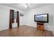 Bedroom with wood-look flooring and a large TV mounted on the wall at 1731 Urbana Ave, Deltona, FL 32725
