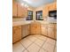Kitchen featuring wooden cabinets, stainless steel dishwasher and a double bowl sink under a window at 1731 Urbana Ave, Deltona, FL 32725