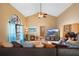 Bright living room featuring vaulted ceilings, hardwood floors, a large window, and ample seating, offering a welcoming space at 1731 Urbana Ave, Deltona, FL 32725