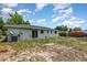 The backyard has a white house with green roof, and has scattered grass at 1808 Green Pl, Ormond Beach, FL 32174
