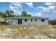 The backyard has a white house with green roof, and has scattered grass at 1808 Green Pl, Ormond Beach, FL 32174