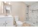 Updated bathroom featuring white vanity and a shower with elegant marble-look tiling at 1808 Green Pl, Ormond Beach, FL 32174