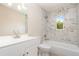 Bright bathroom with a modern vanity, updated fixtures, and combined tub and shower with tiled surround at 1808 Green Pl, Ormond Beach, FL 32174