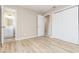 Inviting bedroom features wood-look flooring, white trim, and closet with sliding doors at 1808 Green Pl, Ormond Beach, FL 32174