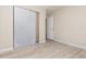 Bedroom featuring wood-look flooring, neutral walls, and sliding-door closet for storage at 1808 Green Pl, Ormond Beach, FL 32174