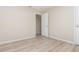 Bedroom features wood-look flooring, neutral walls, and an open door to a connecting room at 1808 Green Pl, Ormond Beach, FL 32174