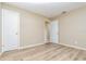 Bright bedroom featuring wood-look flooring, neutral walls, and white doors for a clean, modern aesthetic at 1808 Green Pl, Ormond Beach, FL 32174
