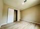 Bedroom features light wood flooring and a closet, great for storage at 1808 Green Pl, Ormond Beach, FL 32174