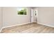 Bedroom with wood-look flooring, neutral walls, and natural light from a window at 1808 Green Pl, Ormond Beach, FL 32174