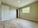 Bright bedroom with light wood floors and a window for natural light at 1808 Green Pl, Ormond Beach, FL 32174