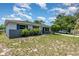 A charming home exterior featuring blue shutters and lush landscaping at 1808 Green Pl, Ormond Beach, FL 32174