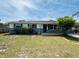 Inviting home featuring a lovely front yard with mature palm trees at 1808 Green Pl, Ormond Beach, FL 32174