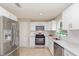 Updated kitchen with stainless steel appliances, white cabinets, and natural light at 1808 Green Pl, Ormond Beach, FL 32174