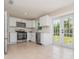 Well-appointed kitchen with stainless steel appliances and access to the outdoor patio through French doors at 1808 Green Pl, Ormond Beach, FL 32174