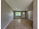 Cozy living room showcasing tiled flooring, neutral paint, and abundant natural light, creating a warm and welcoming atmosphere at 1808 Green Pl, Ormond Beach, FL 32174
