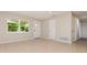 Bright living room with neutral walls, tile flooring, and a large window for ample natural light at 1808 Green Pl, Ormond Beach, FL 32174