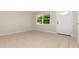 Inviting living area with tile flooring, bright natural light, and a view of the front yard at 1808 Green Pl, Ormond Beach, FL 32174