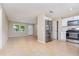 Bright, tiled living space next to an updated kitchen with stainless steel appliances at 1808 Green Pl, Ormond Beach, FL 32174