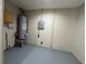 Spacious utility room with a water heater, and concrete flooring at 1808 Green Pl, Ormond Beach, FL 32174