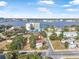 Bight aerial view shows home situated by a beautiful body of water and lush trees at 216 Earl St, Daytona Beach, FL 32118