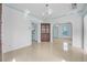Spacious dining area featuring tile floors, a chandelier, and an open archway leading into the kitchen area at 216 Earl St, Daytona Beach, FL 32118