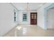 Bright dining room with tile floors, a chandelier, paneled walls, and a large window for natural light at 216 Earl St, Daytona Beach, FL 32118