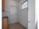 Entryway with tile floors, white door, and window to backyard at 216 Earl St, Daytona Beach, FL 32118