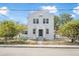 Bright two-story stucco home featuring a gated front yard and a sturdy, classic architectural design at 216 Earl St, Daytona Beach, FL 32118