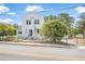 Exterior street view displays this home with a white stucco finish and gated front yard at 216 Earl St, Daytona Beach, FL 32118