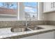 Bright kitchen sink beneath window with a double basin and granite countertop at 216 Earl St, Daytona Beach, FL 32118