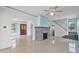 Tile floors, a brick fireplace, and views into the dining room and stairway define this living room space at 216 Earl St, Daytona Beach, FL 32118