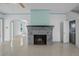 Open-concept living room with a gray brick fireplace and a doorway leading to a dining area and kitchen at 216 Earl St, Daytona Beach, FL 32118