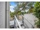 View of a side deck with stairs and a grey railing at 216 Earl St, Daytona Beach, FL 32118