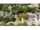 An aerial view of a property with a long driveway, a main house, and surrounded by lush greenery and trees at 220 Buena Vista St, Debary, FL 32713