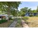 The exterior of this beautiful blue home is framed by a long driveway and plenty of mature trees at 220 Buena Vista St, Debary, FL 32713