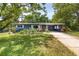 Charming home with a well-manicured lawn, lush landscaping, and a convenient carport at 220 Buena Vista St, Debary, FL 32713