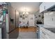 Bright kitchen featuring white cabinets, stainless steel appliances, with view to dining area at 220 Buena Vista St, Debary, FL 32713