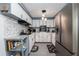 Modern kitchen featuring white cabinets, stainless steel appliances, and stylish backsplash at 220 Buena Vista St, Debary, FL 32713