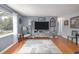 Bright living room features hardwood floors, gray walls, a large window, and comfy furniture at 220 Buena Vista St, Debary, FL 32713