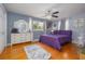 Serene main bedroom with hardwood floors, large window, stylish dresser and bedding for a peaceful retreat at 220 Buena Vista St, Debary, FL 32713