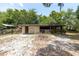 This property includes a large outbuilding surrounded by a partially fenced-in yard and sandy play area at 220 Buena Vista St, Debary, FL 32713