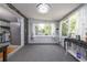 Inviting sun room with lots of natural light, neutral carpet, and adjacent to kitchen, perfect for modern living at 220 Buena Vista St, Debary, FL 32713