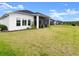 Large grass lawn with view of home at 225 Mosaic Blvd, Daytona Beach, FL 32124