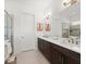 Stylish bathroom boasting a double vanity with granite countertops, modern fixtures, and a glass-enclosed shower at 225 Mosaic Blvd, Daytona Beach, FL 32124