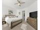 Comfortable bedroom featuring a large bed with plush bedding, a ceiling fan, and neutral decor at 225 Mosaic Blvd, Daytona Beach, FL 32124