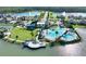 Aerial view of community pool, clubhouse, and lake with fountains at 225 Mosaic Blvd, Daytona Beach, FL 32124