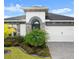 Charming single-story home boasting lush landscaping, stone accents, and an attached two-car garage at 225 Mosaic Blvd, Daytona Beach, FL 32124